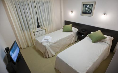 Postel nebo postele na pokoji v ubytování Hotel Polans