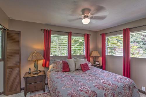 a bedroom with a bed and two windows with red curtains at Hale O Nani Mala Pua home in Pahoa