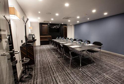 a conference room with a long table and chairs at Holiday Inn Birmingham City by IHG in Birmingham