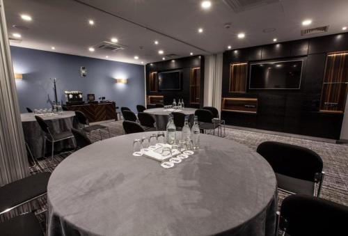 a room with a table with wine glasses on it at Holiday Inn Birmingham City by IHG in Birmingham