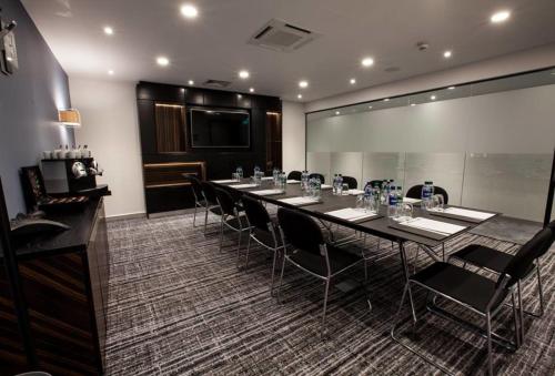 a conference room with a long table and chairs at Holiday Inn Birmingham City by IHG in Birmingham