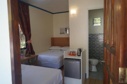 מיטה או מיטות בחדר ב-Camiguin VIAJEROS House Rental