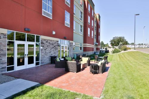 a building with chairs and tables outside of it at Holiday Inn Bismarck, an IHG Hotel in Bismarck