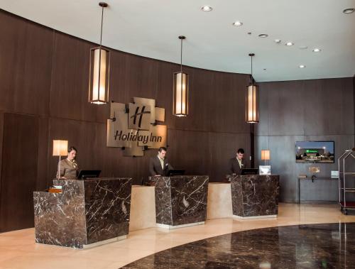 a group of people standing in a lobby at Holiday Inn Bucaramanga Cacique by IHG in Bucaramanga