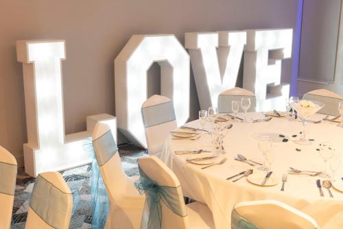 a dining room with a table and chairs and a large sign at Holiday Inn Birmingham M6, Jct7 by IHG in Birmingham