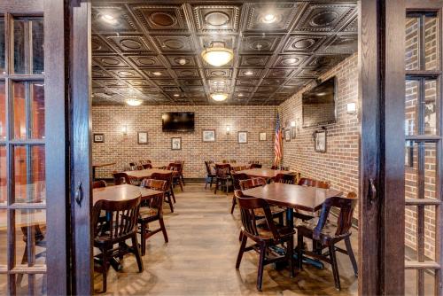 a dining room with wooden tables and chairs at Holiday Inn Spearfish-Convention Center by IHG in Spearfish