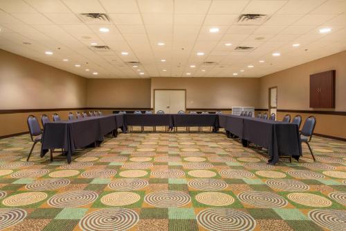 a conference room with a long table and chairs at Holiday Inn Bloomington-University Area by IHG in Bloomington