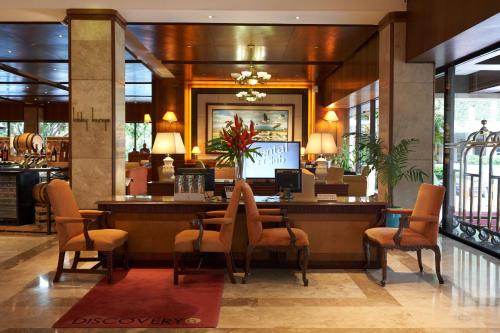 a lobby with a restaurant with a table and chairs at Marco Polo Plaza Cebu in Cebu City