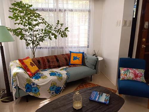 AJ's Haven Homestay في مدينة سيبو: غرفة معيشة مع أريكة وطاولة