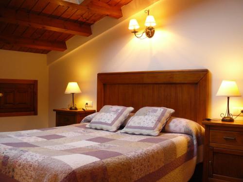 a bedroom with a bed with two pillows on it at Casa Rural El Rincón de Elena in San Esteban de Gormaz