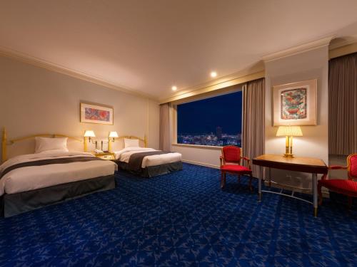 a hotel room with two beds and a window at Rihga Royal Hotel Hiroshima in Hiroshima