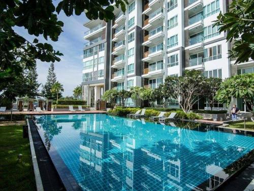 a large swimming pool in front of a building at Ban View Viman Condo in Hua Hin