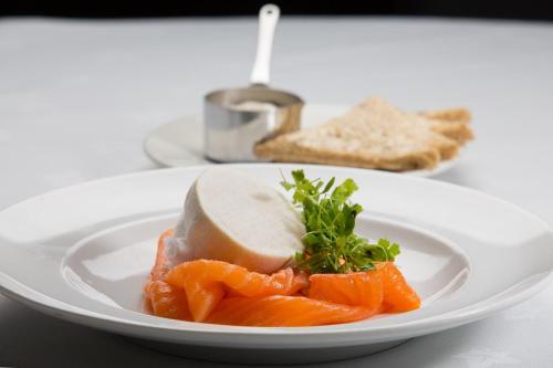 a plate of food with carrots and cheese on a table at Holiday Inn Dumfries by IHG in Dumfries