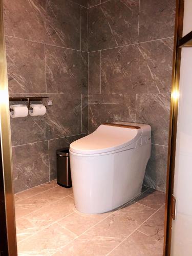 a bathroom with a white toilet in a room at Mercure Shanghai Hongqiao Central in Shanghai