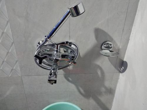 a shower head in a bathroom with a toilet at Royal Riders Camp in Hundar