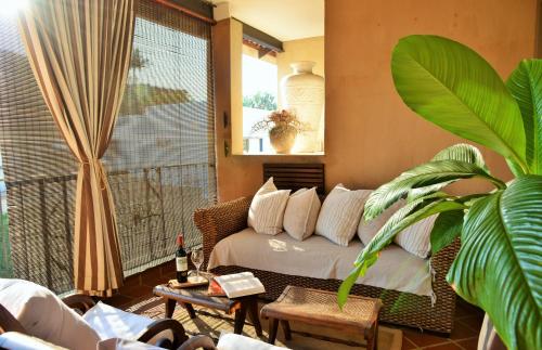 a living room with a bed and a large window at The Vineyard on Ballito in Ballito