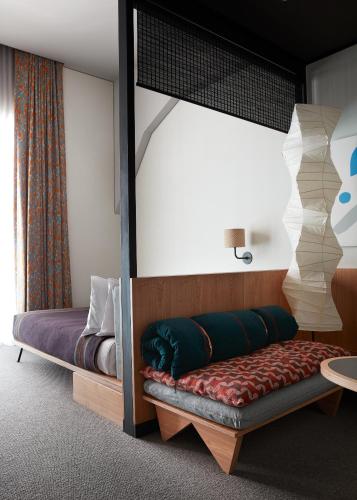 a bedroom with a bunk bed with a bench at Ace Hotel Kyoto in Kyoto