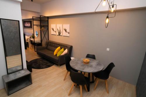 a living room with a table and a couch at Revo Pavilion Bukit Jalil by Ody Suites in Kuala Lumpur