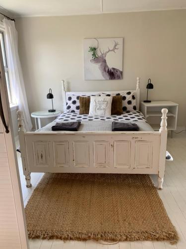 a white bed with pillows on it in a bedroom at Cooper's Cottage in Nelson