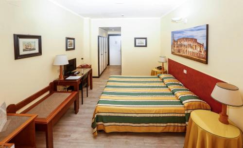 a hotel room with a bed and a table and chairs at Hotel Giardino d'Europa in Rome