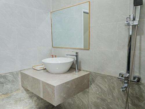 a bathroom with a sink and a mirror at Yurii Hotel in Phan Thiet