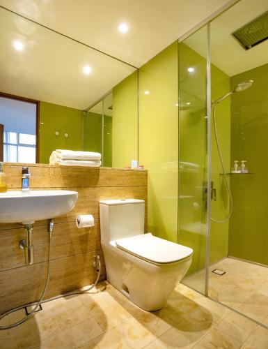 a bathroom with a toilet and a sink and a shower at Yemala Suites at Vortex KLCC in Kuala Lumpur