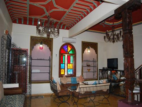 un soggiorno con divano e una vetrata colorata di Résidence Miramare Marrakech a Marrakech
