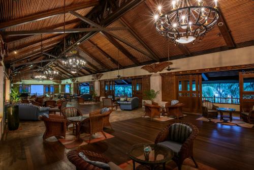 a lobby at the resort with tables and chairs at Nexus Resort & Spa Karambunai in Kota Kinabalu