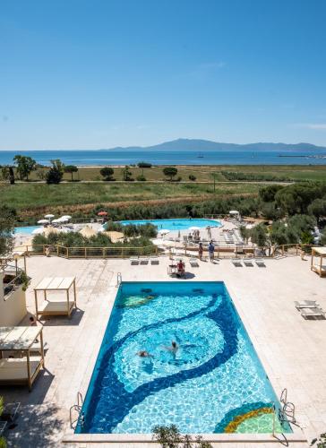 a pool at a resort with people swimming in it at Pigna Felice Talamone in Talamone