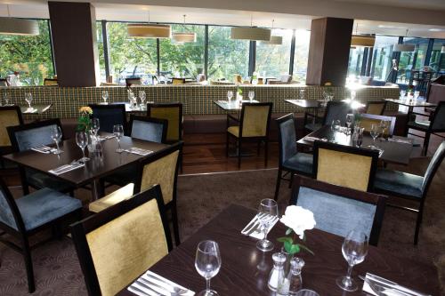 a dining room with tables and chairs and a restaurant at Holiday Inn Bristol City Centre by IHG in Bristol