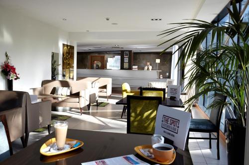 a restaurant with tables and chairs and a lobby at Holiday Inn Bristol City Centre by IHG in Bristol