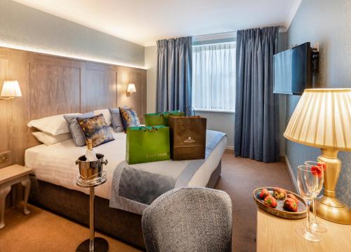 a hotel room with a bed and a table at Avalon House Hotel in Castlecomer