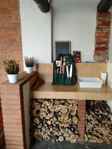 a wooden counter with a pile of fire wood at Country Corner Lago Maggiore in Divignano