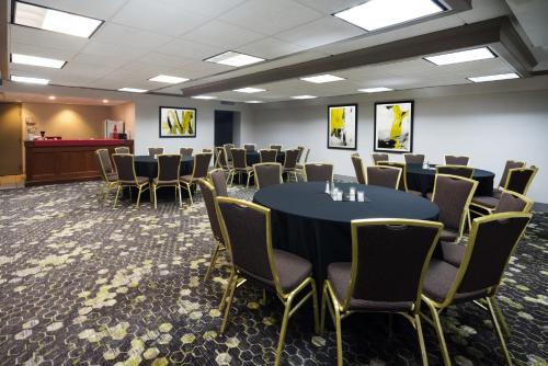 a conference room with a table and chairs at enVision Hotel & Conference Center Mansfield-Foxboro in Mansfield