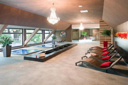 a living room with a pool table and chairs at Holiday Inn Trnava by IHG in Trnava