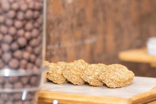 a pile of oatmeal cookies sitting on a cutting board at Hotel One Tariq Road Multan in Multan