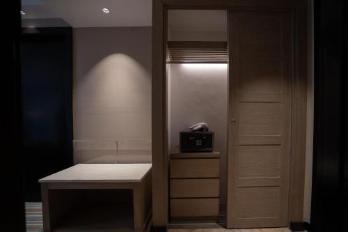 a room with a closet with a desk and a door at Marco Polo Plaza Cebu in Cebu City