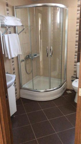 a bathroom with a shower and a toilet at Olbia Residence Hotel in Antalya