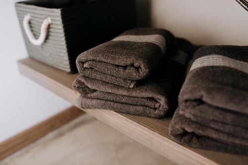 a pile of towels sitting on a shelf at Magnolia Park in Engure