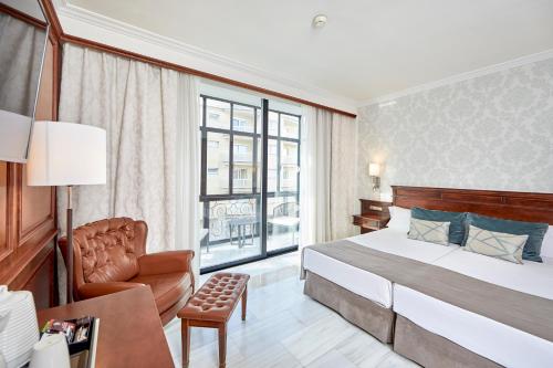 a hotel room with a bed and a chair at Bordoy Continental Palma in Palma de Mallorca