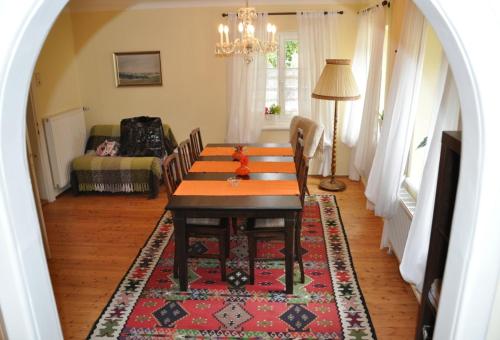 a dining room with a table and a rug at Das Pernerhaus in Pöllau