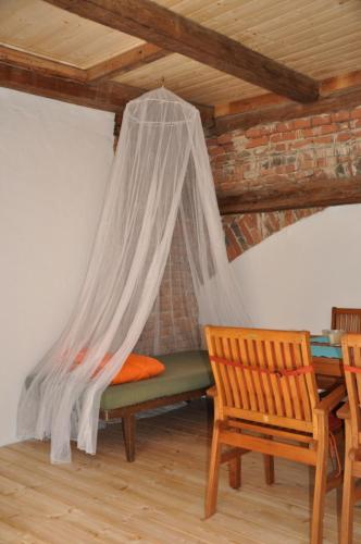 a bedroom with a bed with a mosquito net at Das Pernerhaus in Pöllau