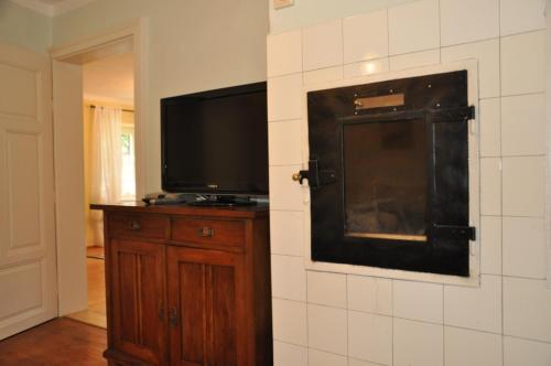 a living room with a flat screen tv on a wall at Das Pernerhaus in Pöllau