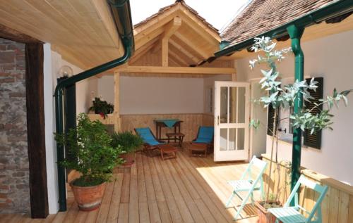 a patio with chairs and a table on a wooden deck at Das Pernerhaus in Pöllau
