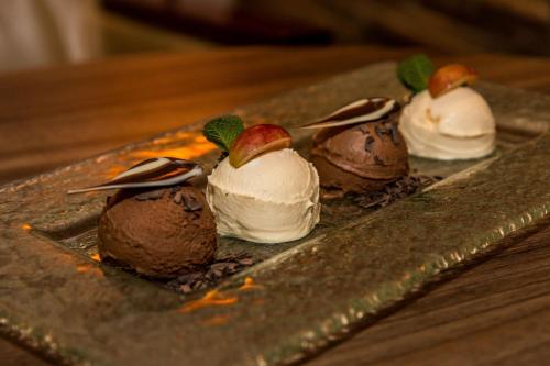 a plate with three chocolate desserts on a table at Holiday Inn Budapest-Budaörs by IHG in Budaörs