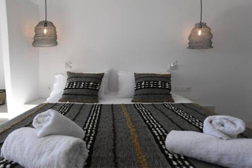 a bedroom with a large bed with two pillows at Dream House "A" in Tinos