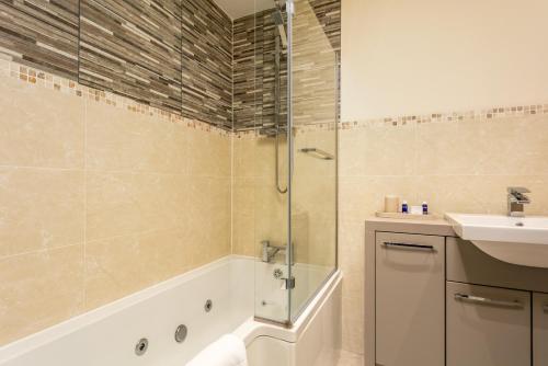 a bathroom with a shower and a sink at The Lucas - Donnini Apartments in Ayr