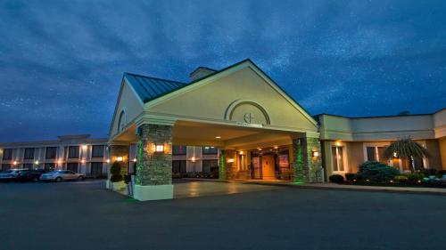a large building with a parking lot in front of it at Buffalo Airport Hotel in Cheektowaga