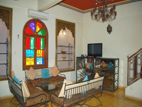 a living room with a couch and a stained glass window at Résidence Miramare Marrakech in Marrakech