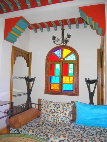 a room with a bed and a stained glass window at Résidence Miramare Marrakech in Marrakech